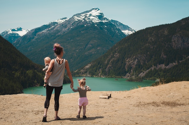 Woman gazing at mountain landscape with family